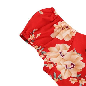 Detail of red floral dress showing elastic ruffled puff sleeves and high-quality woven fabric
