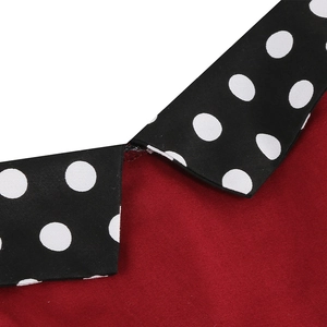 Detailed close-up of a vintage 1950s red dress featuring a black polka dot collar