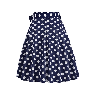 Detail of navy polka dot A-line skirt with high waist and decorative bow accent