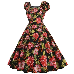 Detail of vintage Hepburn dress featuring vibrant floral print and elegant puff sleeves