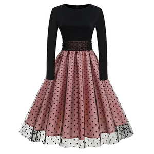 Detail of vintage long sleeve dress with pink polka dot skirt and black mesh overlay