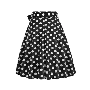 Detail view of vintage A-line skirt with black and white polka dots and a side bow knot