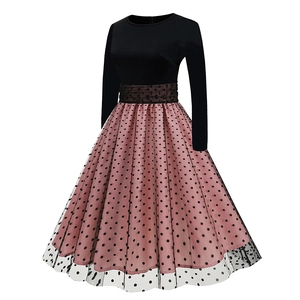 Detail of long sleeve dress featuring black bodice and pink polka dot mesh tutu skirt