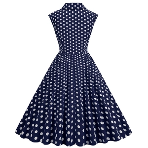 Detail view of the back of a 1950s vintage dark blue polka dot sleeveless dress