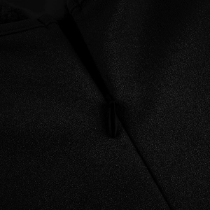 Close-up of invisible back zipper on black V-neck lace dress with textured fabric detail
