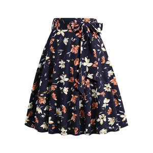 Detailed flat lay of navy blue A-line skirt with orange floral print and waist bow tie
