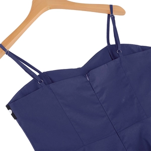 Detail of navy blue dress with adjustable straps and hidden back zipper on a wooden hanger