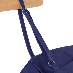 Detailed close-up of adjustable shoulder straps with silver metal buckles on a navy dress