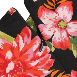 Macro view of hidden zipper closure on a vintage black floral dress with tropical print