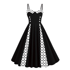 Detail of 50s vintage black dress with white polka dot patchwork and decorative buttons