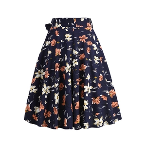 Detail of floral A-line skirt with high waist and orange flower print on navy blue fabric