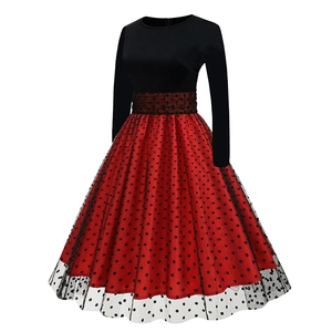 Detail of red polka dot skirt layering with black transparent mesh overlay and belt