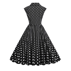 Back view of a 1950s vintage polka dot dress with retro lapel and wide swing skirt