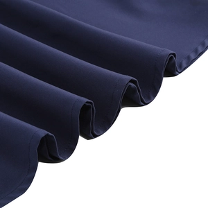 Detail of dark blue vintage gothic dress showing matte fabric texture and pleated hem stitching