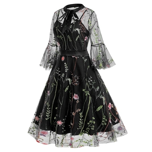 Detailed view of dark gothic mesh dress with colorful floral embroidery and bow tie neck