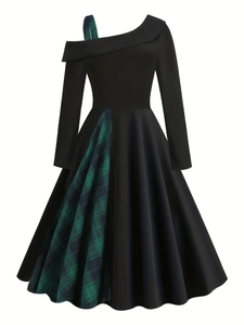 Detail of the asymmetric one-shoulder neckline with plaid strap on a black dress