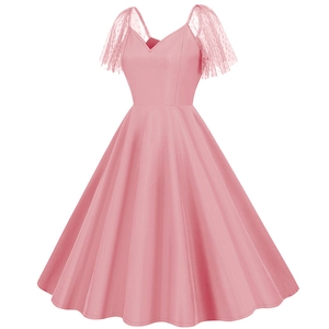 Close-up detail of pink retro dress with sheer mesh polka dot lace ruffled sleeves