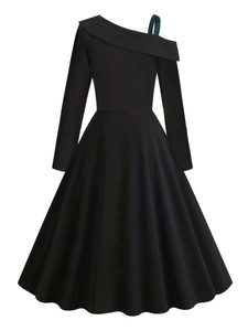 Detail of the elegant asymmetrical neckline with green plaid strap on this black dress