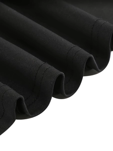 Detail of double-needle stitching and wave pleats on black fabric hemline