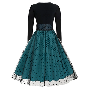 Detail view of the back of a vintage dress with dark teal mesh and black polka dots