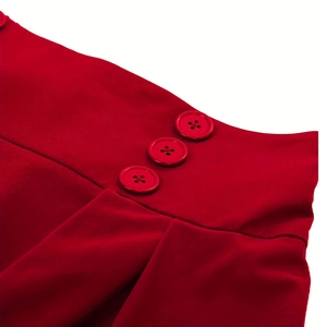 Close-up of red high-waisted skirt with three buttons and pleats on the waist