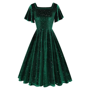 Détail du tissu en velours vert foncé avec paillettes argentées et manches volantées