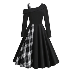 Detail of the asymmetric plaid strap and off-shoulder neckline on the black dress