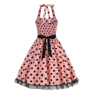 Detail view of pink polka dot vintage dress with elastic smocked back and waist bow