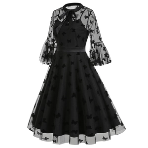Close-up of the black mesh dress with velvet butterfly embroidery and lace-up neck detail