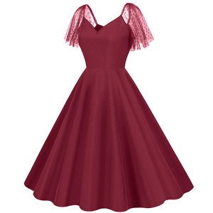 Detail of V-neckline and polka dot mesh sleeves on a vintage wine red A-line dress