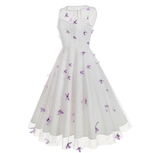 Close-up of white mesh dress featuring intricate embroidery and 3D purple butterflies