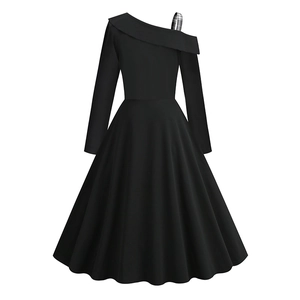 Detail of black one-shoulder dress with a contrast houndstooth strap and flared A-line hem