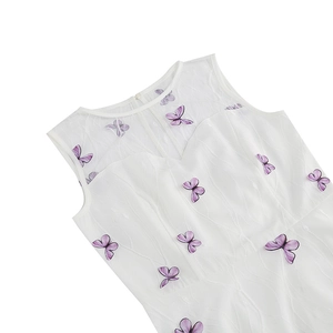 Detail of white round neck sleeveless dress featuring purple butterfly embroidery on mesh