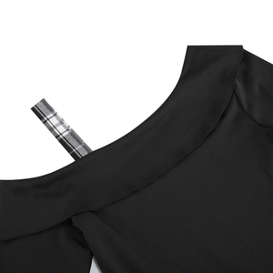 Detailed close-up of the black off-shoulder neckline with a vintage plaid strap detail