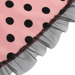 Detail of pink polka dot dress showing black lace mesh trim and ruffled hemline texture