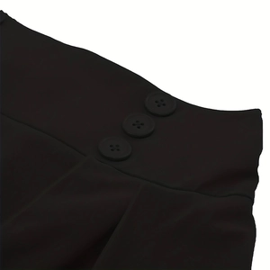 Close-up of decorative buttons and fabric texture on a vintage black casual skirt