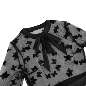 Detail of gothic mesh dress featuring a silk bow tie neck and butterfly floral embroidery