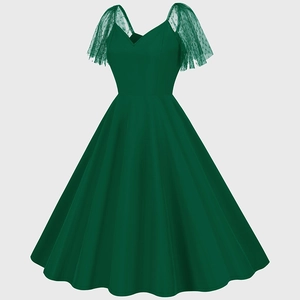 Detail of vintage dark green dress showing sheer polka dot mesh ruffled sleeves and V-neck