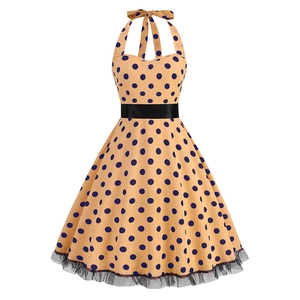 Vintage halter polka dot dress with waist belt and black lace hem on white background