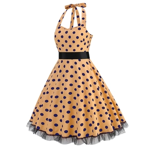 Detail of vintage halter dress featuring navy polka dots and black lace mesh hem trim