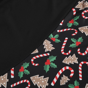 Detail of Christmas vintage dress showing stitching and festive print with candy canes