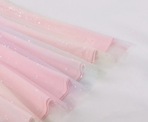 Detailed macro view of pink tulle layers with sparkling silver sequins and wavy hem edge