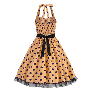 Detail view of vintage polka dot dress featuring elastic smocked back and black ribbon bow
