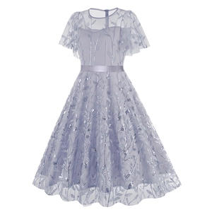 Close-up of light purple mesh dress featuring silver sequin leaf patterns and satin belt