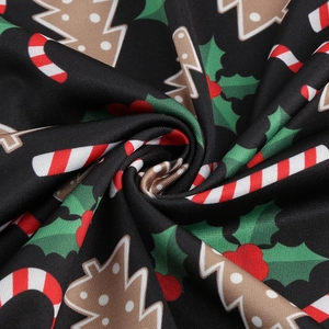 Macro shot of vintage Christmas fabric with Mickey motifs and candy cane patterns