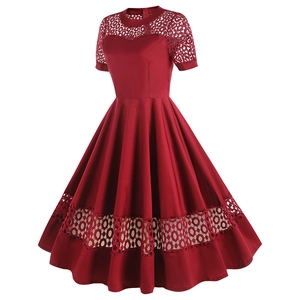 Detailed view of dark red cocktail dress featuring hollow lace patterns and round neck