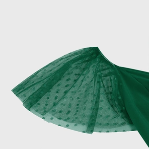 Detail of dark green Swiss dot mesh sleeves on a vintage Hepburn style flared dress