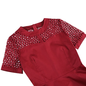 Detail of elegant lace patchwork on the neckline and short sleeves of a burgundy dress