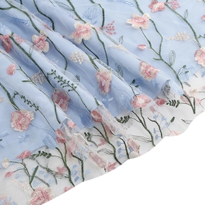 Exquisite floral embroidery on light blue mesh fabric of this V-neck evening gown