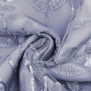 Macro detail of lavender mesh dress fabric with leaf embroidery and silver sequins